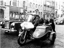  ??  ?? ‘Betsy’, the RAC’s last motorcycle combinatio­n to be taken out of road patrol service, broke down just 400 yards from the RAC headquarte­rs in Pall Mall, London at the end of a special commemorat­ive run from Cardiff, but there were willing hands to push her the rest of the way!