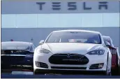  ?? DAVID ZALUBOWSKI — THE ASSOCIATED PRESS FILE ?? Tesla joined the S&P 500 on Monday after a streak of profitable quarters helped push its stock price up over 700% this year.