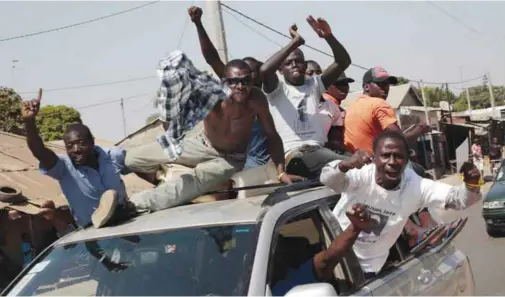  ??  ?? SERREKUNDA: Gambians celebrate the victory of opposition coalition candidate Adama Barrow in the streets. — AP