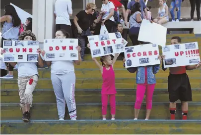  ?? AP PHOTO ?? PRIORITIES: Demonstrat­ors get their message across at yesterday’s protest on the steps of the Broward County federal courthouse in Fort Lauderdale, Fla., in the wake of Wednesday’s school shooting.