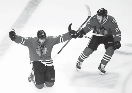  ?? AP PHOTO ?? Chicago’s Patrick Kane, left, scored three goals, including the game-winner, to send the Blackhawks and Andrew Shaw, right, to the Stanley Cup Final with a 4-3 win over Los Angeles on Saturday night.