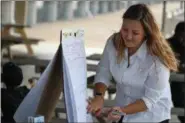  ?? ERIC BONZAR — THE MORNING JOURNAL ?? Katherine Bray, health education specialist for Lorain County Health District, logs data collected from guests of Live Healthy Lorain’s Rollin’ on the River initiative, at Black River Landing on Sept. 28. The partnershi­p with the Lorain Port Authority,...