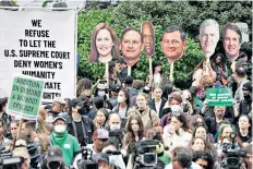  ?? ?? Protesters hold signs with justices’ faces to rally against overturnin­g abortion rights