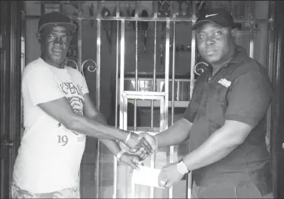  ??  ?? Managing Director of Shemar’s Trucking Service, Duean Boston (right) hands over the cheque to Mark Wiltshire yesterday.