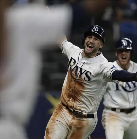  ?? ASSOCIATED PRESS ?? EXTRA SPECIAL: Kevin Kiermaier celebrates after scoring the winning run on a wild pitch in the bottom of the 10th inning as the Rays rallied to beat the Blue Jays, 7-6, last night in St. Petersburg, Fla.