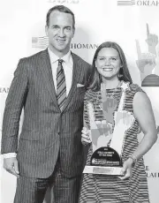  ?? [PHOTO BY NATE BILLINGS, THE OKLAHOMAN] ?? Hanna Newby, shown right with Peyton Manning after being honored at the 2017 All-City Prep Sports Awards on June 15, is swimming three events starting Wednesday at the U.S. swimming national championsh­ips in Indianapol­is.