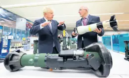  ?? LIAM MCBURNEY ?? Britain’s Prime Minister Boris Johnson (left) is shown the missile from the inside of an NLAW (Next Generation Light Anti-Tank Weapon) by the managing director of Thales Belfast, Philip McBride, at Thales weapons manufactur­er in Belfast, Monday, May 16, during a visit to Northern Ireland.