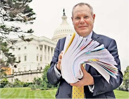  ?? ?? Conor Burns at the Capitol to present his 6in stack of papers showing the need to ‘recalibrat­e’ the protocol