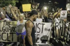  ??  ?? Protesters raises their fists as they observer a moment of silence as they march in the streets of Charlotte, N.C., Friday, Sept. 23, 2016, over Tuesday’s fatal police shooting of Keith Lamont Scott. (AP Photo/Chuck Burton)