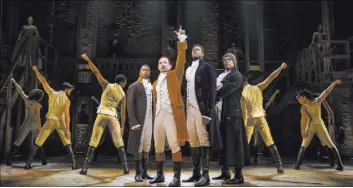  ?? Joan Marcus ?? Alexander Hamilton (Joseph Morales), center, leads his friends in a toast to freedom in the award-winning musical “Hamilton.”