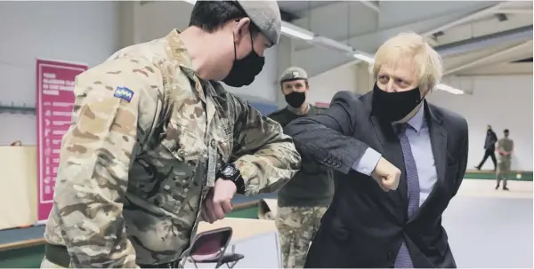  ??  ?? 0 Boris Johnson elbow bumps a soldier during his visit to Scotland yesterday