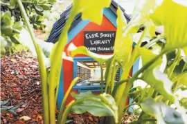  ??  ?? Left: A sign amid the foliage proclaims it the main branch of the Elsie Street Library. It was built by neighbor Marty Combs.