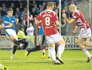  ??  ?? Declan John fires home Rangers’ opening goal. Picture: SNS.