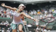  ?? LIONEL BONAVENTUR­E / GETTY IMAGES ?? Top seed Angelique Kerber of Germany, who lost Sunday, returns a shot to Russia’s Ekaterina Makarova during their first-round match at the French Open in Paris.