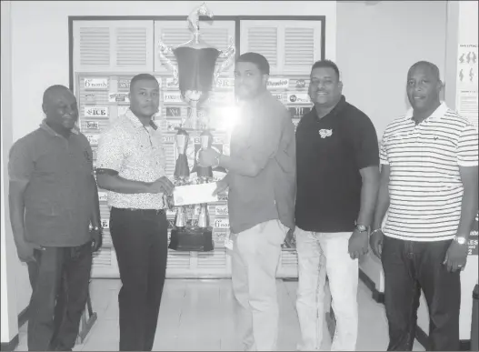  ??  ?? Rawle Nedd (Banks Beer Trainer Manager) (second left) presents the sponsorshi­p package to Nasrudeen Junior Mohamed (Guyana Cup Promoter) while Troy Peters (Communicat­ions Manager , Roy Jafarally (Race Organiser) and Mortimer Stewart (Outdoor Events...