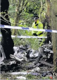  ??  ?? WRECKAGE Police officers at the scene of crash