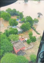  ?? HT PHOTO ?? Relief materials being dropped by an IAF chopper over Hemaguda, Bhatwas, Chintalwad­a villages in Jalore on Tuesday.