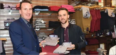  ??  ?? Damien Clifford from Listry being shown the latest designs in Andre shirts and chinos by Enda Walshe at Quill’s Menswea, Killarney.