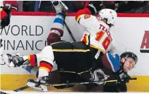  ?? .THE ASSOCIATED PRESS ?? The Flames’ Matthew Tkachuk lands on Colorado’s Mikko Rantanen during the second period on Wednesday night in Denver