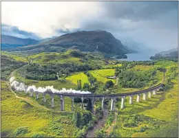  ??  ?? A steam train crosses the famous Glenfinnan Viaduct