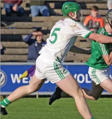  ??  ?? Naomh Eanna wing-forward Charlie McGuckin under pressure from Shamrocks defender Evan Shefflin.