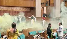  ?? FILE PHOTO ?? A video grab shows an unidentifi­ed man jumping from the visitor’s gallery of Lok Sabha and spraying gas canisters in the House during the Winter Session of Parliament in New Delhi.