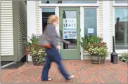  ?? AP-robert F. bukaty, File ?? A shopper walks by one of several vacant retail spaces among the outlet shops in Freeport, Maine.