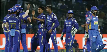  ?? Picture: VISHAL BHATNAGAR/NURPHOTO VIA GETTY IMAGES ?? GOTCHA: Mumbai Indians players celebrate the wicket during the IPL T20 match against Rajasthan Royals in Jaipur last April.