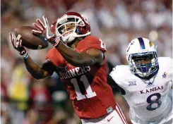  ?? Associated Press ?? n Oklahoma wide receiver Dede Westbrook (11) makes a catch for a touchdown ahead of Kansas cornerback Brandon Stewart (8) during the first half of an NCAA college football game Oct. 29 in Norman, Okla. Westbrook was selected Offensive Player of the...