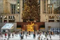  ?? Bloomberg photo by Christophe­r Occhicone ?? Skaters are seen at the Rockefelle­r Center ice rink in New York on Dec. 4, 2021.