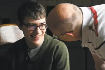  ?? Thomas Peipert / Associated Press ?? Lukas Inman, 19, who uses cannabis to treat his rare and severe form of epilepsy called Lennox-Gastaut Syndrome, talks with his father at their home in Colorado Springs.