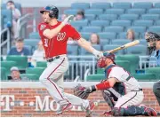  ?? EPA ?? The Nationals’ Max Scherzer hits a single against the Braves in the 14th inning.