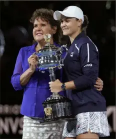  ?? Simon Baker/Associated Press ?? It was only fitting that Evonne Goolagong Cawley be the one to present the Australian Open championsh­ip trophy to Ash Barty Saturday in Melbourne, Australia.