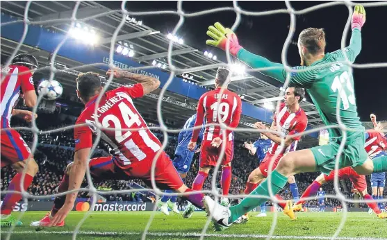  ?? Picture: Getty. ?? Leicester striker Jamie Vardy (obscured) fires past Atletico Madrid keeper Jan Oblak to bring the Foxes back into the game.