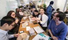  ?? CARLOS OSORIO/TORONTO STAR ?? Transit advocate Kevin Vuong, in white shirt, organized a lunch for commuters who wanted to show support for King Street business.