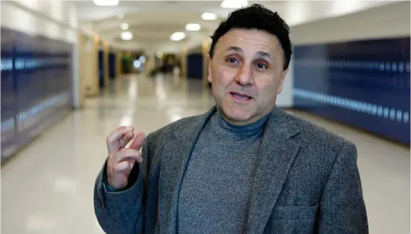  ?? (Photo by Ed Andrieski, AP) ?? In this April 18, 2009 file photo Columbine High School Principal Frank DeAngelis crosses his fingers wishing that everything goes well with the School's Prom as he talks with reporters in the hallway at the school near Littleton, Colo. Following...