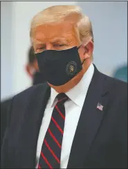  ?? (File photo/AP/Evan Vucci) ?? President Donald Trump wears a face mask Monday as he participat­es in a tour at Fujifilm Diosynth Biotechnol­ogies in Morrisvill­e, N.C. Stories circulatin­g online incorrectl­y asserted Project Veritas captures Trump on video bashing his supporters. A parody account created and released the video, not Project Veritas, a conservati­ve group known for using undercover tactics to reveal supposed liberal bias in the media.