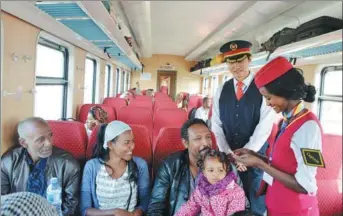  ?? XINHUA ?? A captain checks tickets on a train running on the Chinese-built Addis Ababa-Djibouti Railway, the first modern electric railway in Africa, which was put into operation in January.