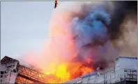  ?? PHOTO: AP ?? Fire and smoke rise out of the Old Stock Exchange, Boersen, in Copenhagen yesterday.