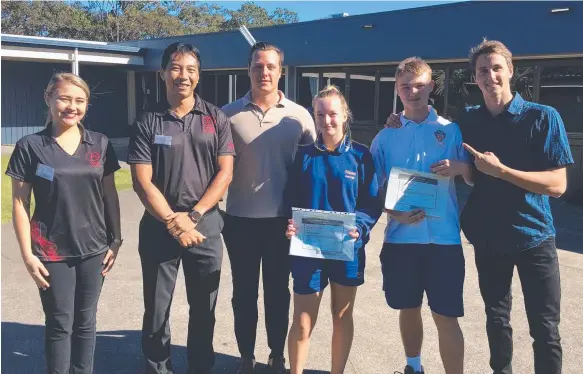  ??  ?? Hayden McEvoy (third left) and A Team Tuition members with Miami State High School students Skylah Rambold (Year 9) and Waide Carson (Year 10) after they were presented with certificat­es by Australian Olympic swimmer Cameron McEvoy (right) for winning...