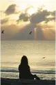  ?? LYNNE SLADKY/AP 2010 ?? A woman meditates on the beach in Miami Beach, Fla.