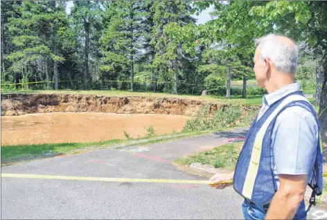  ?? DARRELL COLE – AMHERST NEWS ?? Mike Johnson, Cumberland County’s EMO coordinato­r, looks over the sinkhole in the Oxford Lions Park following a media briefing on Tuesday.