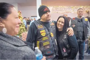  ?? MARLA BROSE/JOURNAL ?? Marty Gagne and his wife, Amy Gagne, chat with Patricia Savage, left, of the Albuquerqu­e Police Department at the Rock of Salvation Worship Center on Thursday as bikers, cops and chaplains united for Project Hope to distribute food and toys to needy...