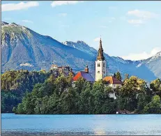  ?? Rick Steves’ Europe/DOMINIC ARIZONA BONUCCELLI ?? One popular Ljubljana day trip is a visit to Lake Bled, with its iconic churchtopp­ed island ringed by monumental peaks.