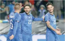  ?? — Reuters ?? Italy’s Matteo Politano celebrates scoring their first goal with Marco Verratti and Stefano Sensi in Genk.