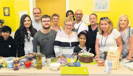  ??  ?? Helping hands Volunteers at the Friday night‘curry Kitchen’with reporter Kirsten Mcstay