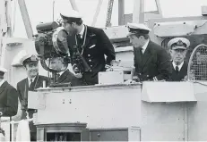  ??  ?? PROUD Lord Mountbatte­n watches as Prince Charles brings his minehunter HMS Bronington alongside at HMS Vernon, Portsmouth