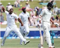  ?? AFP ?? Shannon Gabriel of West Indies (left) celebrates after taking the wicket of New Zealand’s Jeet Raval (right) in Hamilton. —