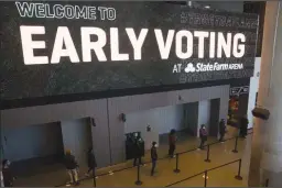  ?? MEGAN VARNER/GETTY IMAGES ?? Early voters in Georgia’s Jan. 5 runoff election stand in line at the State Farm Arena on Dec. 14, 2020, in Atlanta.