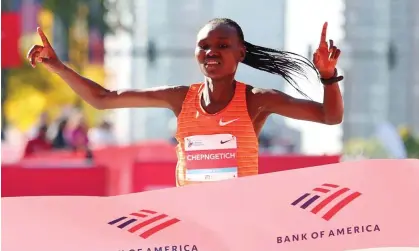  ?? ?? Ruth Chepngetic­h celebrates as she crosses the finish line to win the women’s 2022 Chicago Marathon. Photograph: Michael Reaves/Getty Images